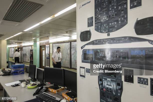 People walk through a maintenance control center of China Southern Airlines Co. In Guangzhou, China, on Thursday, Nov. 2, 2017. China Southern...