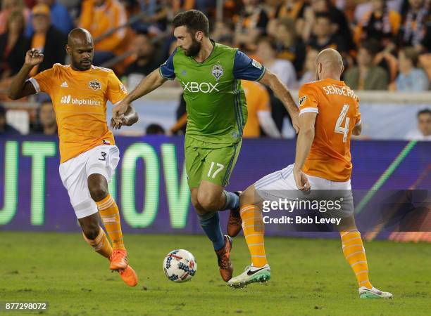 Will Bruin of Seattle Sounders dribbles between Adolfo Machado of Houston Dynamo and Philippe Senderos in the first half at BBVA Compass Stadium on...