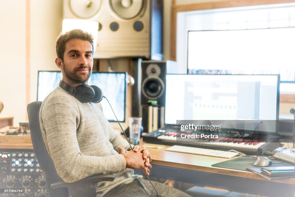Confident man in sound recording studio