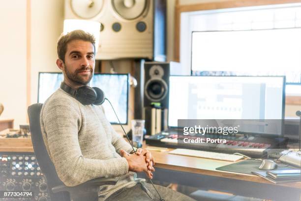 confident man in sound recording studio - arts culture and entertainment stock pictures, royalty-free photos & images