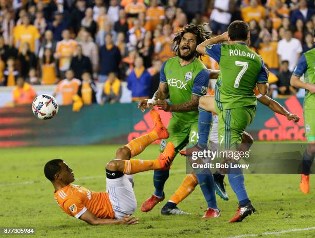 Juan Cabezas of Houston Dynamo attempts to get his foot on the ball as Cristian Roldan of Seattle Sounders steps in as Mauro Manotas and Roman Torres...