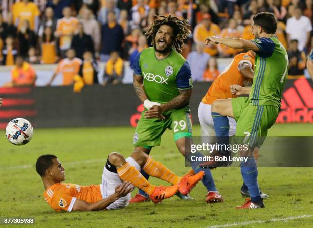 Juan Cabezas of Houston Dynamo attempts to get his foot on the ball as Cristian Roldan of Seattle Sounders steps in as Mauro Manotas and Roman Torres...