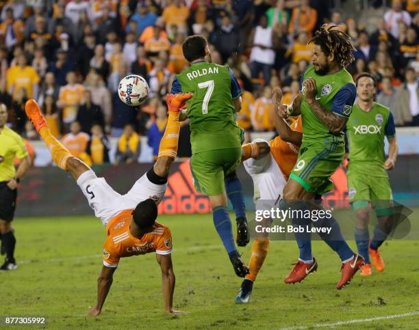 Juan Cabezas of Houston Dynamo attempts to get his foot on the ball as Cristian Roldan of Seattle Sounders steps in as Mauro Manotas and Roman Torres...