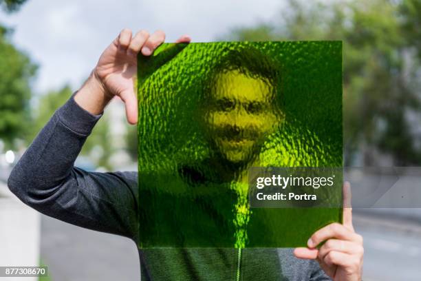 happy worker holding green stained glass on street - frosted glass stock pictures, royalty-free photos & images
