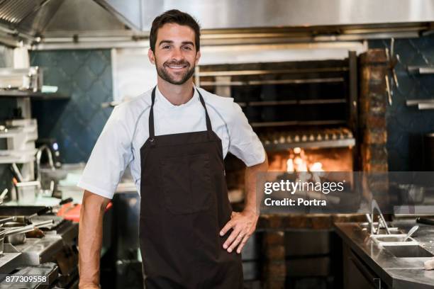 portrait of confident chef in commercial kitchen - apron stock pictures, royalty-free photos & images