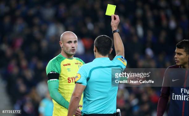 Nicolas Pallois of FC Nantes receives a yellow card from referee Nicolas Rainville during the French Ligue 1 match between Paris Saint Germain and FC...