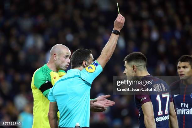 Nicolas Pallois of FC Nantes and Yuri Berchiche of PSG both receives a yellow card from referee Nicolas Rainville during the French Ligue 1 match...