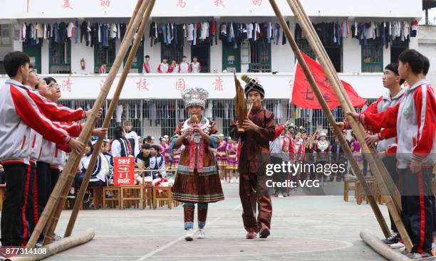 Students compete Bamboo Pole Dance during a traditional sports meeting at a Dong nationality high school in Sanjiang Dong Autonomous County on...