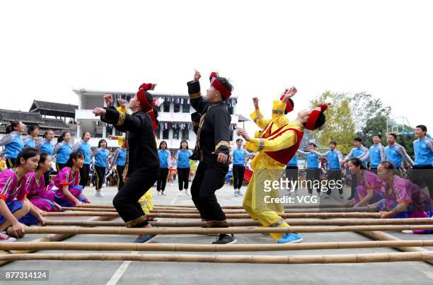 Students compete Bamboo Pole Dance during a traditional sports meeting at a Dong nationality high school in Sanjiang Dong Autonomous County on...