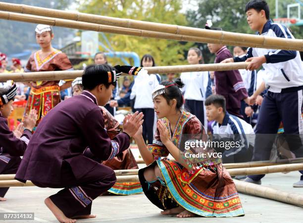 Students compete Bamboo Pole Dance during a traditional sports meeting at a Dong nationality high school in Sanjiang Dong Autonomous County on...