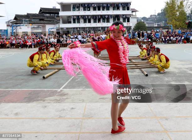 Students compete Bamboo Pole Dance during a traditional sports meeting at a Dong nationality high school in Sanjiang Dong Autonomous County on...