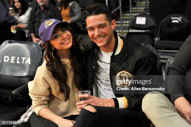 Actress Sarah Hyland and Wells Adams attend a basketball game between the Los Angeles Lakers and the Chicago Bulls at Staples Center on November 21,...