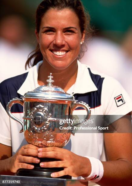 Jennifer Capriati of the USA poses with the trophy after defeating Kim Clijsters of Belgium during the Women's Singles Final of the French Open...