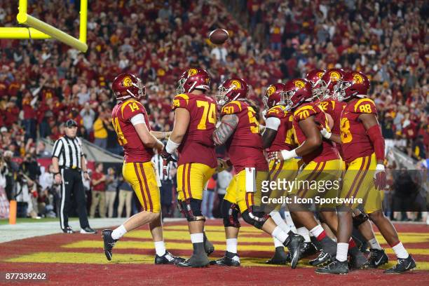 Sam Darnold of the USC Trojans and his teamattes celebrate in the end zone after a touchdown during a college football game between the UCLA Bruins...