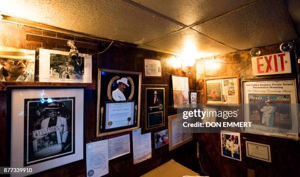 Photos and momentos of Samual Hargress hang on the wall of Paris Blues jazz bar in Harlem on November 17, 2017 in New York. In 1969, Samuel Hargress...