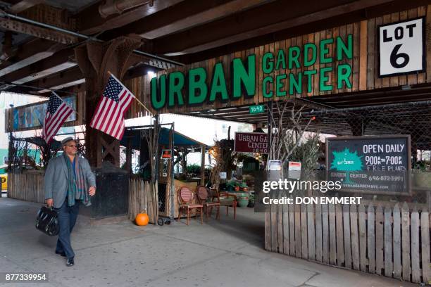 Man walks by the Urban Garden on 116th St. And Park Ave in Harlem on November 14, 2017 in New York. Harlem was the neighborhood where Ella Fitzgerald...