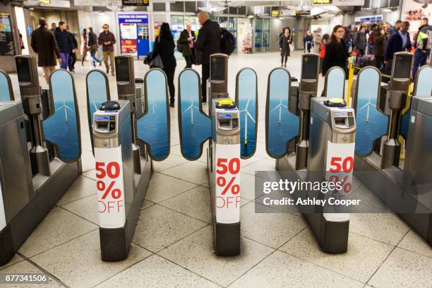 an advert for the lowering cost of offshore wind power on the london underground. - torniquete imagens e fotografias de stock