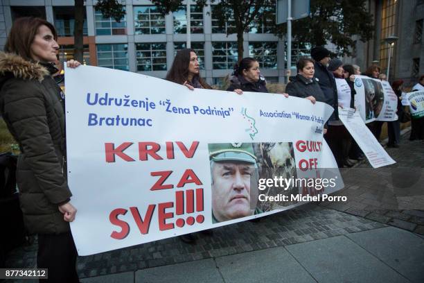 Protesters stand outside the court before former Bosnian military chief Ratko Mladic appears for the pronouncement of the Trial Judgement for the...