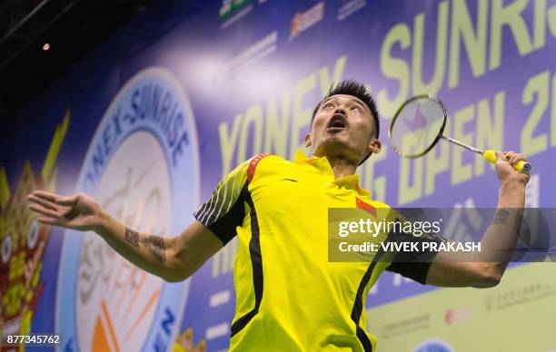 Lin Dan of China hits a shot against Suppanyu Avihingsanon of Thailand during the Hong Kong Open badminton tournament in Hong Kong on November 22,...