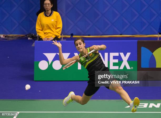 Carolina Marin of Spain hits a shot against Mnatsu Mitani of Japan during the Hong Kong Open badminton tournament in Hong Kong on November 22, 2017....