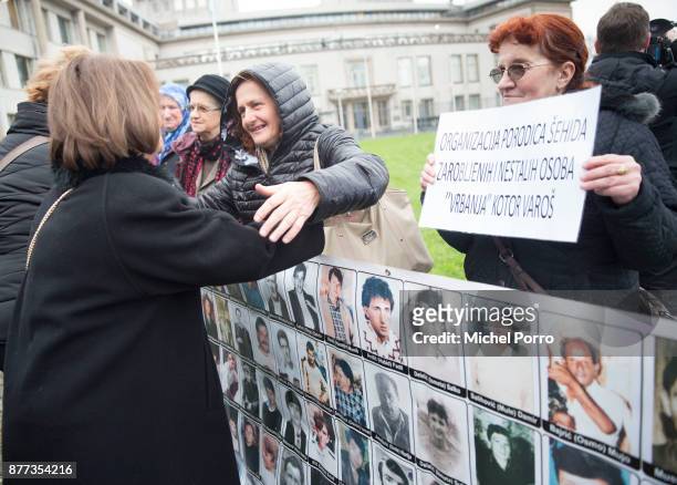 Relative of a victim is hugged outside the court before former Bosnian military chief Ratko Mladic appears for the pronouncement of the Trial...