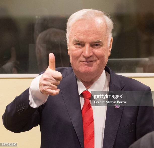 Former Bosnian military chief Ratko Mladic gives a thumbs up as he appears for the pronouncement of the Trial Judgement for the International...