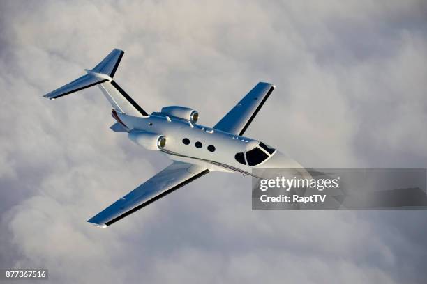 a corporate jet in-flight. - tail fin stock pictures, royalty-free photos & images