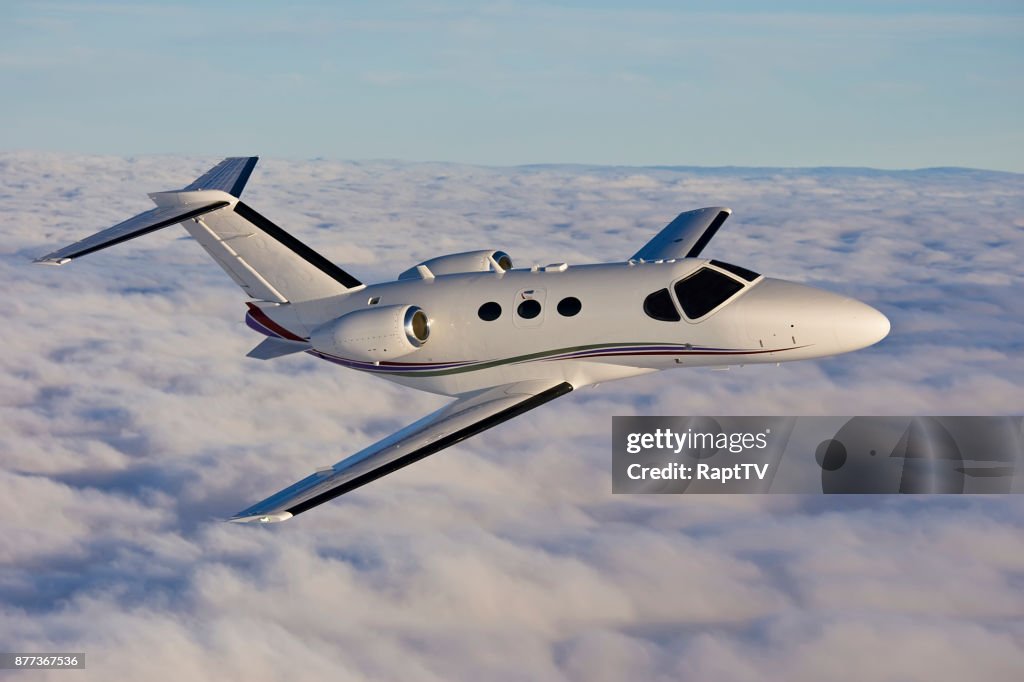 A Private Jet Flying Above the Clouds