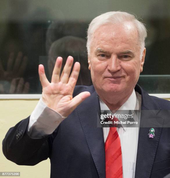 Former Bosnian military chief Ratko Mladic waves as he appears for the pronouncement of the Trial Judgement for the International Criminal Tribunal...