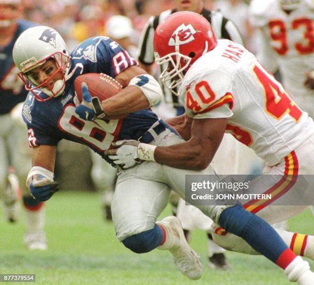 New England Patriots player 88 Terry Glen is brought down by Kansas City Chiefs defender James Hasty in third quarter action of their game at Foxboro...