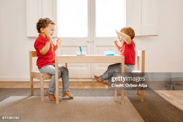 brothers having lunch together - kid sitting stock pictures, royalty-free photos & images