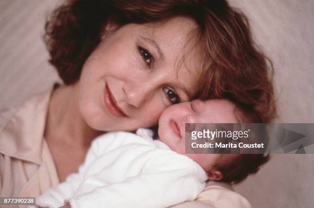 French actress Nathalie Baye with her newborn baby, Laura Smet, who she had with her partner, French singer and actor Johnny Hallyday 25th November...