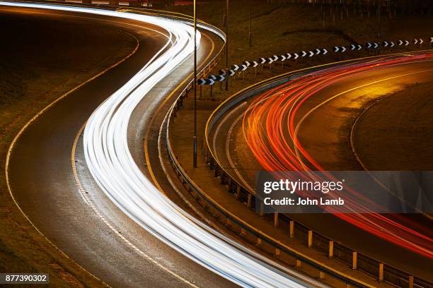 road traffic at night - crash barrier stock pictures, royalty-free photos & images