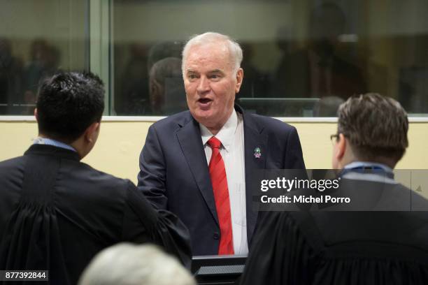 Former Bosnian military chief Ratko Mladic speaks to his lawyers before appearing for the pronouncement of the Trial Judgement for the International...