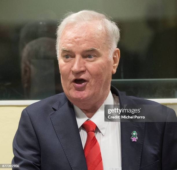 Former Bosnian military chief Ratko Mladic speaks to his lawyers before appearing for the pronouncement of the Trial Judgement for the International...