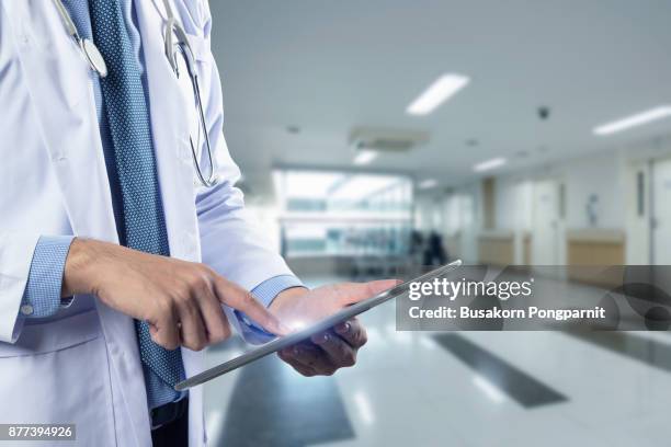 healthcare and medicine. doctor using a digital tablet computer at work - graphics tablet stock pictures, royalty-free photos & images