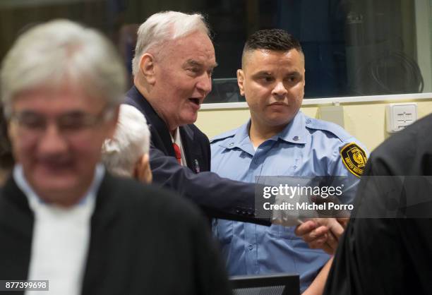 Former Bosnian military chief Ratko Mladic meets his lawyers before appearing for the pronouncement of the Trial Judgement for the International...