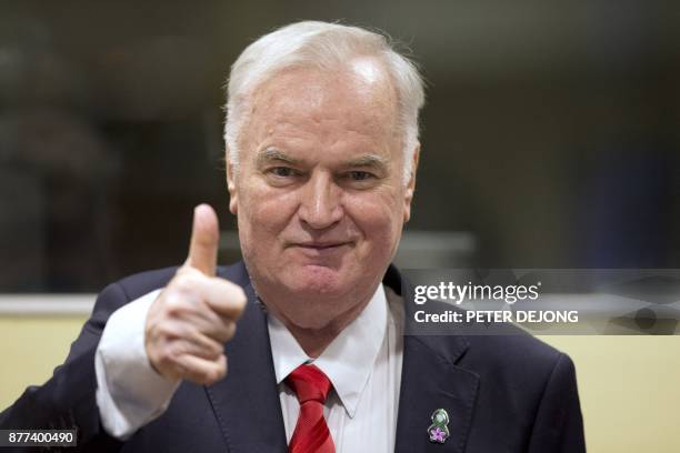 Former Bosnian Serb commander Ratko Mladic thumbs up as he enters the International Criminal Tribunal for the former Yugoslavia , on November 22 to...