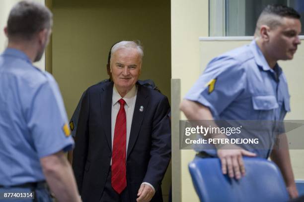 Former Bosnian Serb commander Ratko Mladic smiles as he enters the International Criminal Tribunal for the former Yugoslavia , on November 22 to hear...