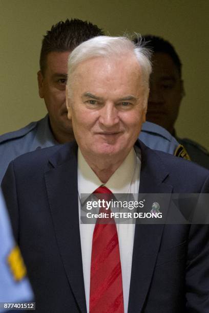 Former Bosnian Serb commander Ratko Mladic smiles as he enters the International Criminal Tribunal for the former Yugoslavia , on November 22 to hear...