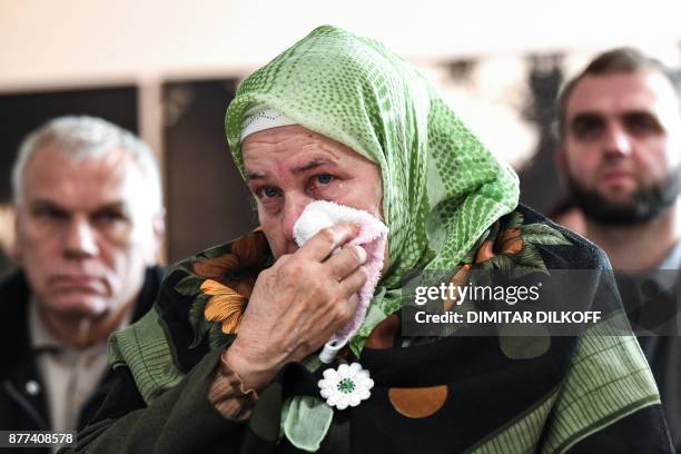 Woman wipes a tear as she gathers with others including relatives of victims of the 1995 Srebrenica massacre to watch a live TV broadcast from the...