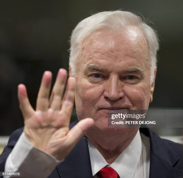 Former Bosnian Serb commander Ratko Mladic waves as he enters the International Criminal Tribunal for the former Yugoslavia , on November 22 to hear...