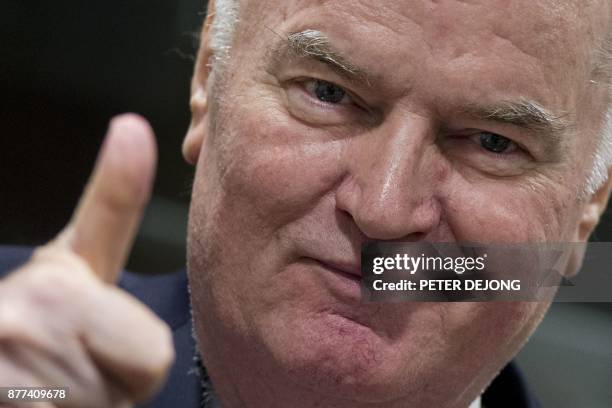 Former Bosnian Serb commander Ratko Mladic thumbs up as he enters the International Criminal Tribunal for the former Yugoslavia , on November 22 to...