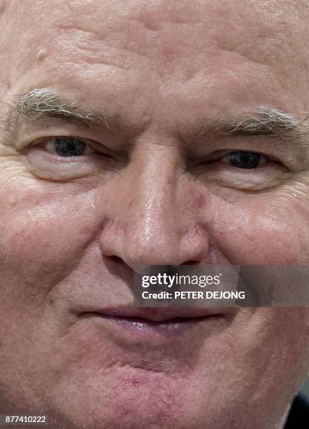 Former Bosnian Serb commander Ratko Mladic smiles as he enters the International Criminal Tribunal for the former Yugoslavia , on November 22 to hear...