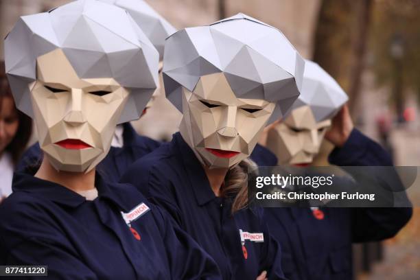 Protestors dressed as 'Maybots' demonstrate at the entrance of Downing Street as cabinet leave following a meeting ahead of the Chancellor's annual...