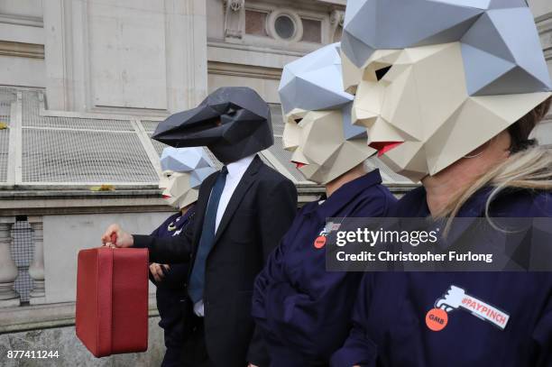 Protestors dressed as 'Maybots' demonstrate at the entrance of Downing Street as cabinet leave following a meeting ahead of the Chancellor's annual...