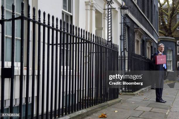 Philip Hammond, U.K. Chancellor of the exchequer, holds the dispatch box containing the budget, outside 11 Downing Street before presenting an annual...