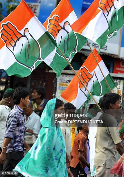 Indian Congress Party supporters carry party flags as they celebrate during a victory rally in Siliguri on May 18, 2009. India's ruling Congress-led...