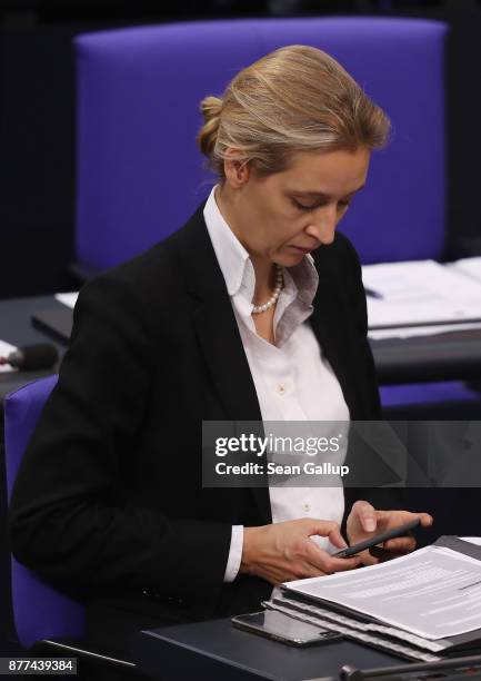 Alice Weidel of the right-wing Alternative for Germany political party types on a smartphone as she attends a Bundestag session on November 22, 2017...