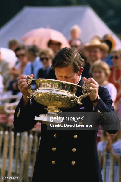 Prince Charles drinks from a Polo trophy at the Cowdray Park polo club in Sussex, in July 1984.